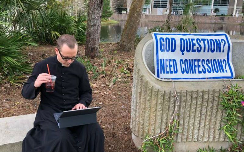 "Need Confession?": Priest's Sign on University Campus Goes Viral