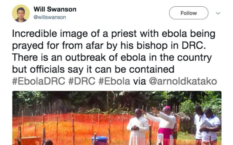 Powerful Photo of Bishop Praying Over Quarantined Priest in Africa Goes Viral