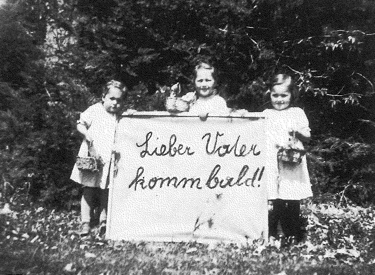 Easter 1943: Franz Jagerstatter’s daughters; Loisi, Rosi, and Maria, holding a sign that reads, “Dear Father, come [home] soon.” Franz was in jail in Linz and was later executed./Styria Verlag. Used with permission